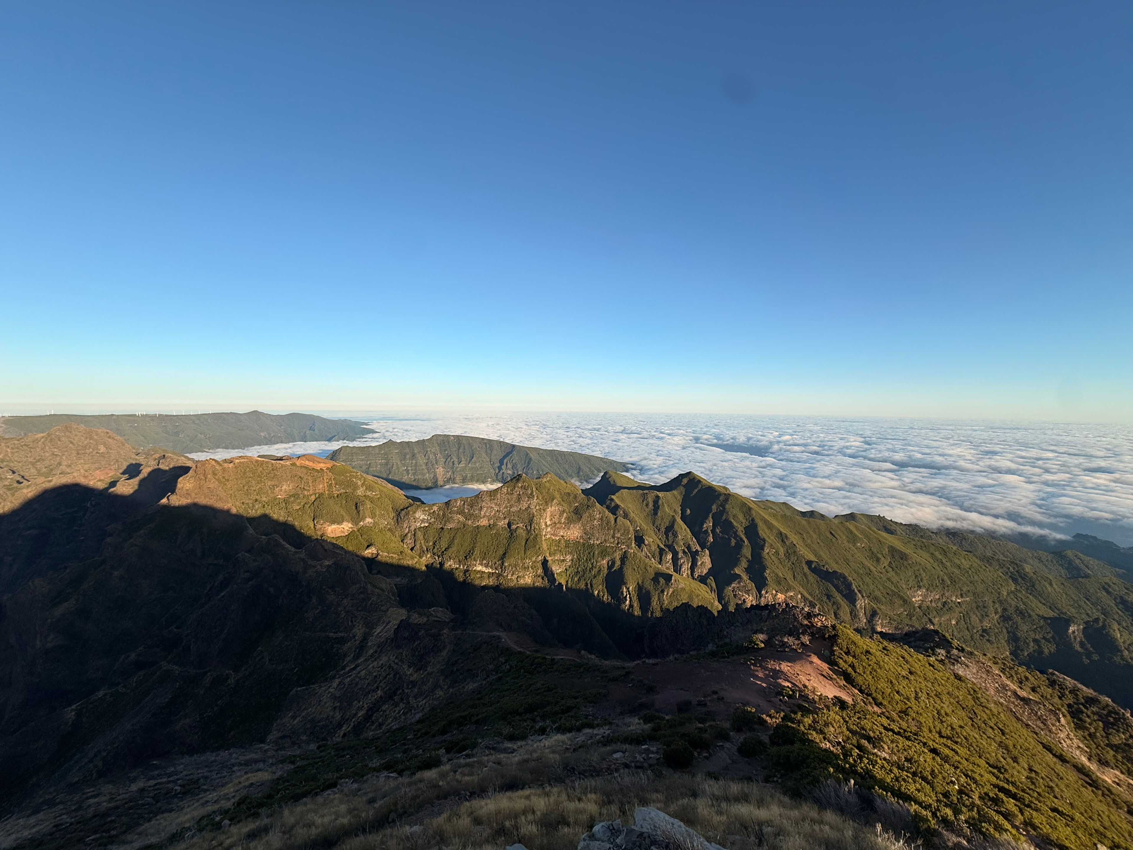 A mountain landscape above the clouds
